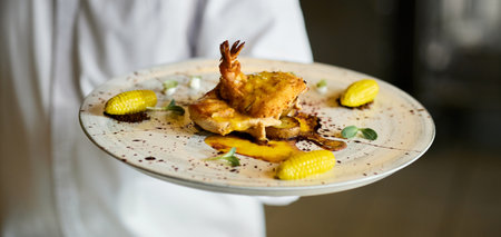 Close-up of the finished main dish in the hands of the cook. high asian cuisine