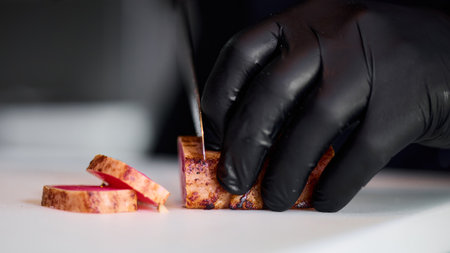 Chef cuts tuna with a knife. Cooking dishes from healthy foods