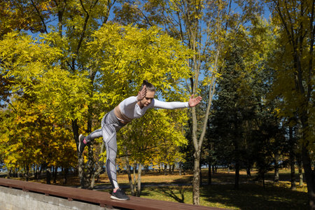Yoga practices outdoors in the park. Training for women outside.の写真素材