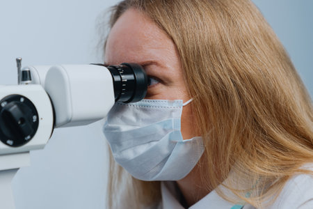 Close-up of a woman's face of an ophthalmologist doctor during a patient's appointment.