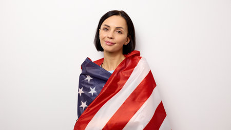 Young woman received American citizenship and holding a flag.の写真素材