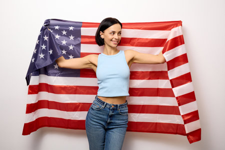Young woman received American citizenship and holding a flag.の写真素材