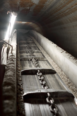Horizontal photo of a conveyor belt in a mine. Extraction of minerals from the bowels of the earth.