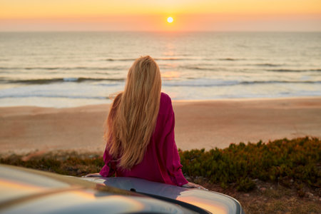 Woman freedom enjoying near the seashore during sunset.の写真素材