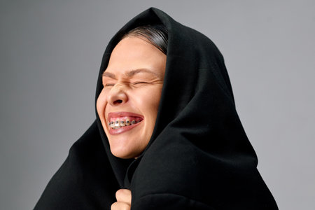 Well-groomed smiling woman with braces on her teeth smiles.の写真素材