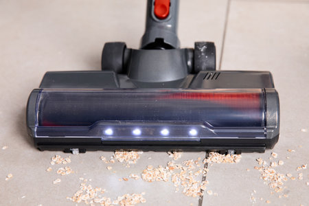 Vacuum cleaner removes debris on the floor.の写真素材
