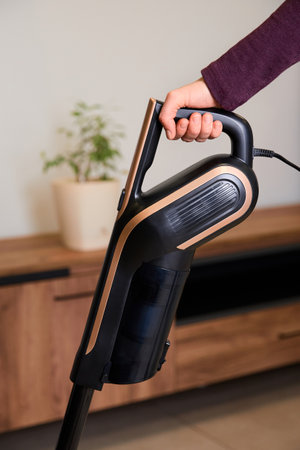Man vacuuming his apartment.の写真素材