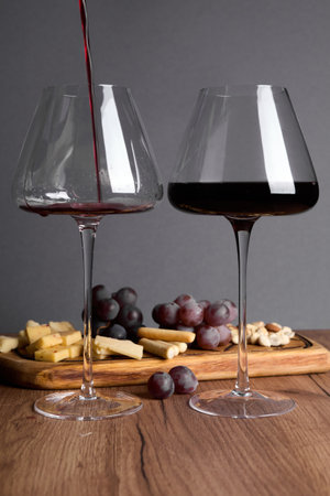Evening dinner with glasses of wine and cheese appetizers.