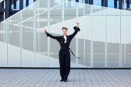 Plastic male dancer dressed in a dance costume charismatically performs choreography.