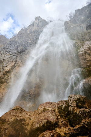Mountain waterfall from melt water flows down.