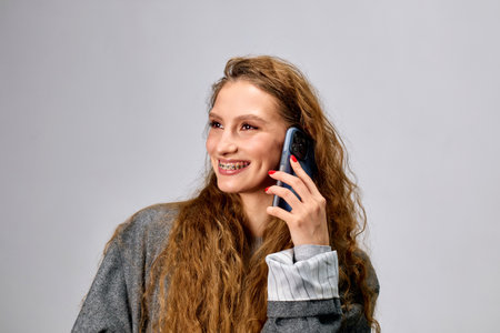 A joyful woman engaged in a phone conversation.