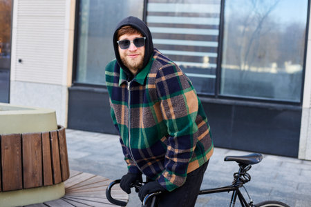 Young city man takes bike for winter city ride.の写真素材