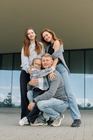 Lifestyle concept, family with daughters child and teenager smiling during walk.