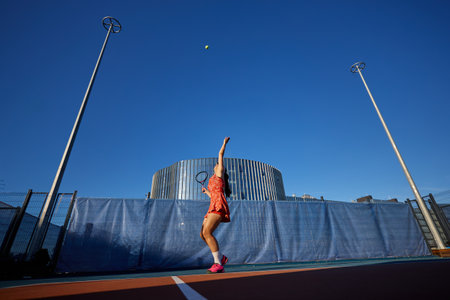 Sports concept, young woman in tennis suit playing on the tennis court.の写真素材