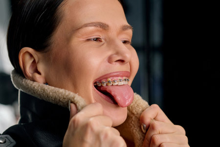 Healthy smile concept, woman smiling with open mouth and braces on teeth.の写真素材