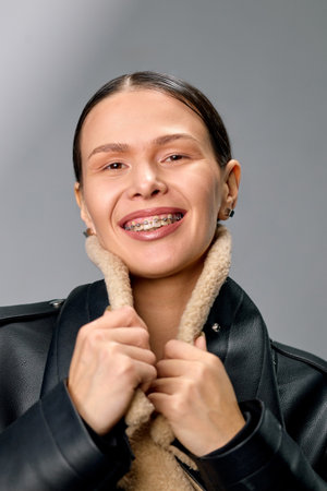 Well-groomed smiling woman with braces on her teeth smiles.の写真素材