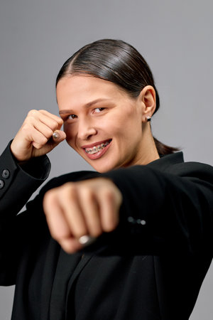 Young brunette woman smiling with braces and looking confidently at the camera.の写真素材