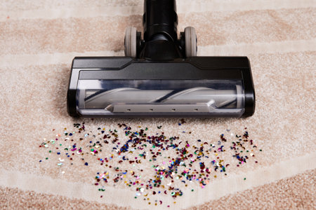 Vacuum cleaner removes spilled crumbs from the floor.の写真素材