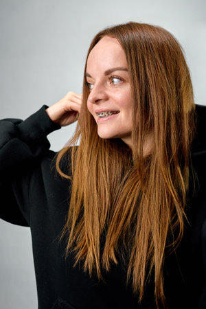 Portrait of a person with braces showing a smile.