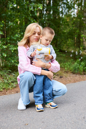 Childhood concept. Mom went out for a walk with her son and hugs him.の写真素材