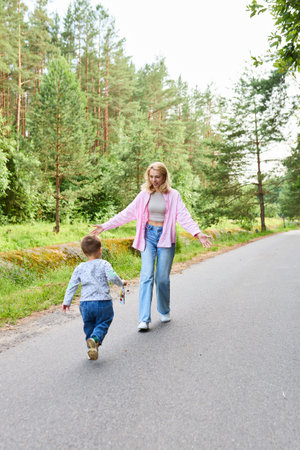 Motherhood concept. Mom and child having fun on a walk.の写真素材