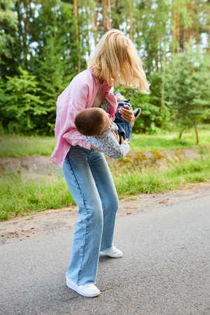 A young mother picked up her child and twirled him around.の写真素材