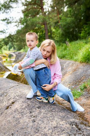 A young mother walks with her son and protects him.の写真素材