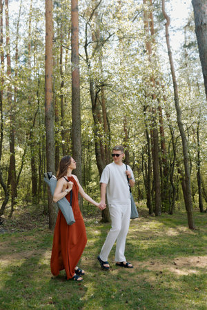 A young couple walks through the forest.の写真素材