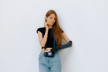 Woman showcases her bionic prosthesis while holding a camera with a joyful expression.