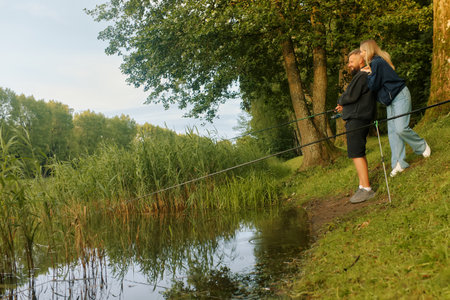Man and woman share a quiet moment while fishing.の写真素材