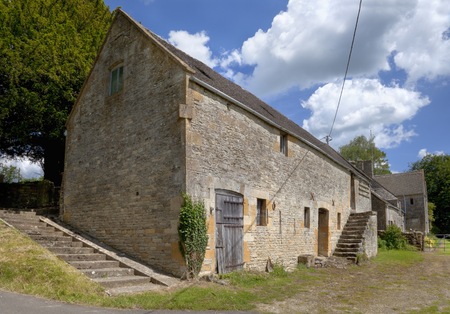 Old stone-built Cotswold barn with dovecote, Hazelton, Gloucestershire, England のeditorial素材