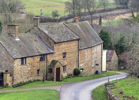 Stone cottages stepping down the hill in Winderton, Warwickshire, England.のeditorial素材