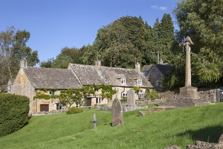 Village cross and cottages at Snowshill, Gloucestershire, England.