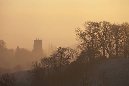 The sun rising on a winters morning over the Cotswold town of Chipping Campden, Gloucesterhisre, England.の写真素材