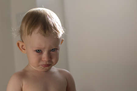 Very capricious little 1-years old child looks at youの写真素材