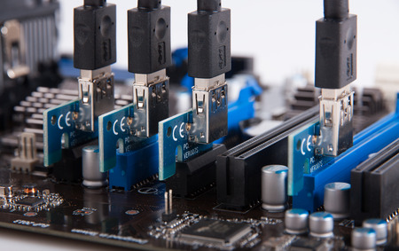 Risers card PCI-e installed in motherboard slotsの写真素材