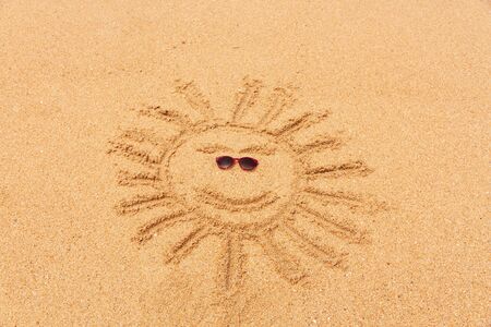 Drawing sun on sand beachの写真素材