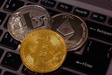 Cryptocurrency coins Bitcoin Litecion and  Ethereum on keyboardの写真素材