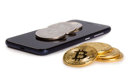 Cryptocurrency coins and smartphone isolated on white backgroundの写真素材