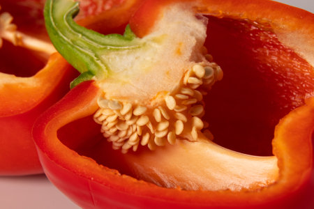 Red bell pepper in section close-up on a white background. High quality photo