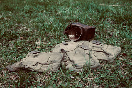 Abandoned military equipment on the green grass. Vintage style.の写真素材