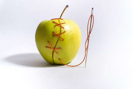 green apple needle stitched red threadの写真素材