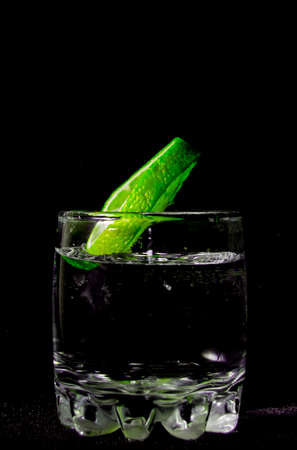 lemon green glass black background water splashの写真素材