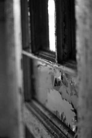 old window in an abandoned house, black and white photo, close-upの写真素材