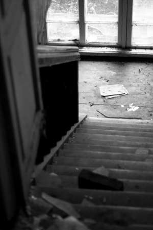 Black and white photo of an old staircase in an abandoned building.の写真素材