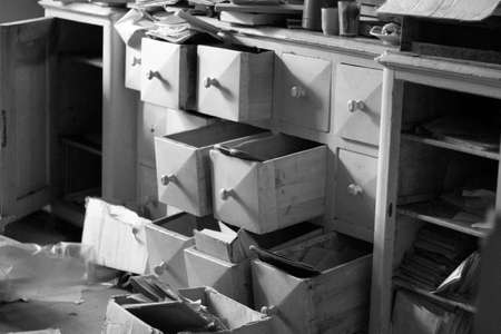 Abandoned wooden chest of drawers. Black and white photo.
