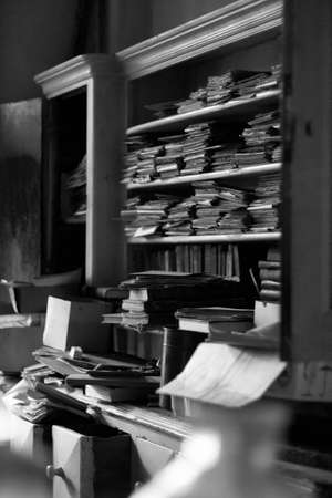 Old books in a library. Black and white photo. Horizontal