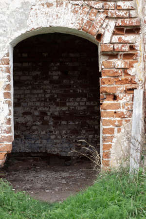 Old brick wall and gate of an abandoned Orthodox church, Russia.の写真素材