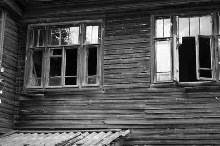 Old wooden house with broken windows. Black and white photo. High quality photoの写真素材