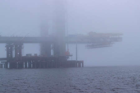Oil and gas platform in the middle of a foggy morning.